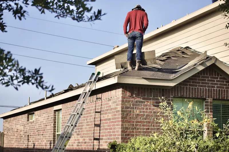 Professional roofer working on a residential roof in Tully Center